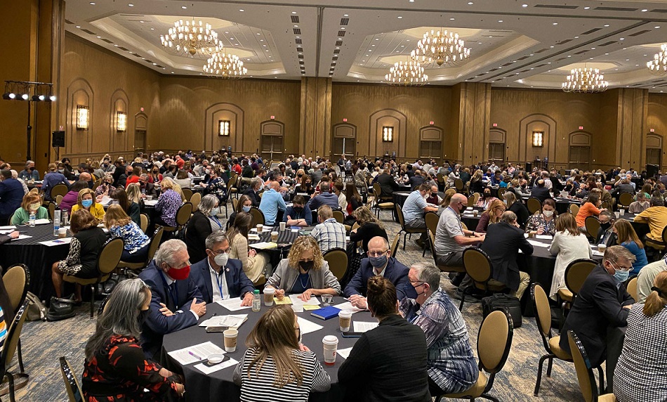 A large gathering of individuals in a conference room from the 2022 NetVUE Conference.