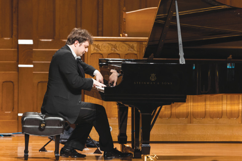 Kenny Broberg playing a grand piano
