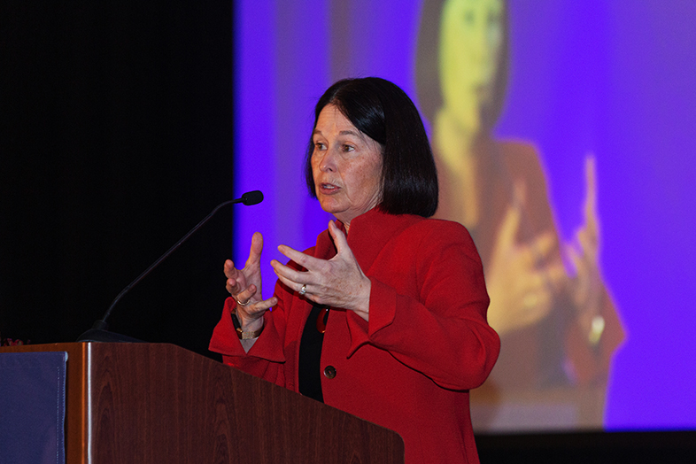 Two photos of Mary B Marcy delivering keynote address at podium