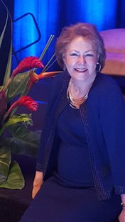 Barbara Hetrick standing in front of an event stage