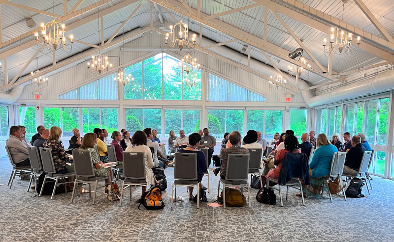 participants seated in chairs arranged in circle
