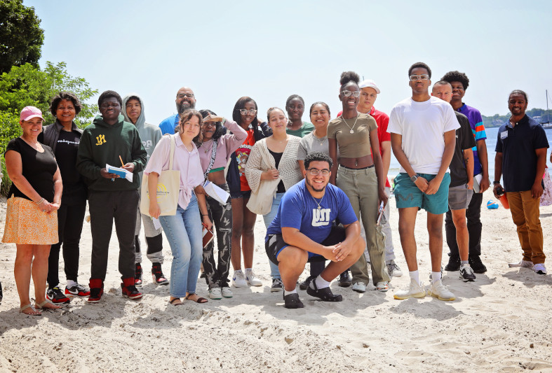 Students standing on a beach