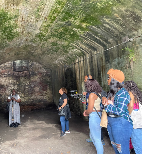 Students standing in an old tunnel
