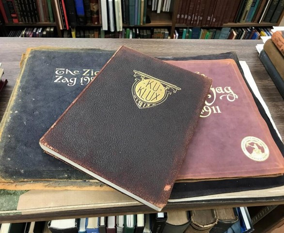 Three yearbooks on a table