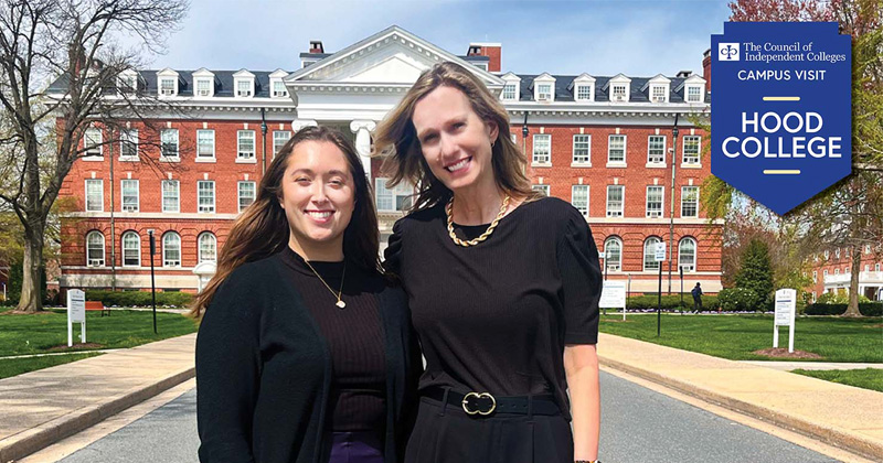 Two CIC staff stand in front of campus building