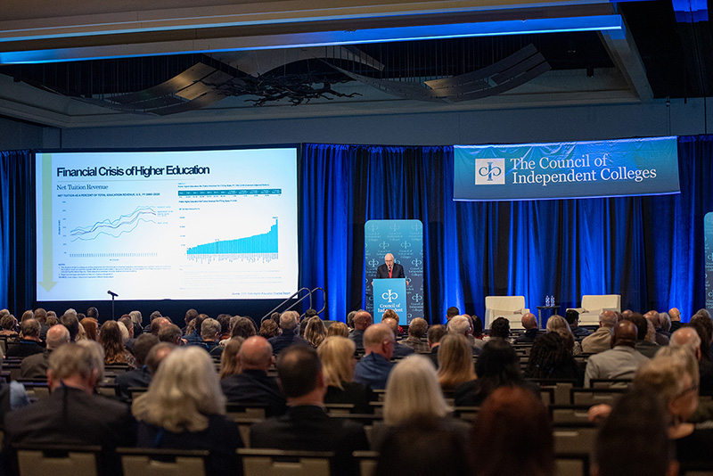 Seated audience listening to Richard Guarasci speak on stage