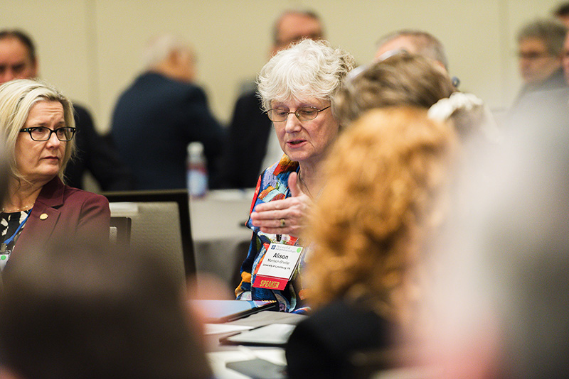 Participants discuss topics at roundtables