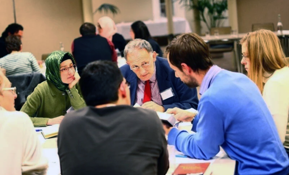 Campus participants sharing reflections at a roundtable