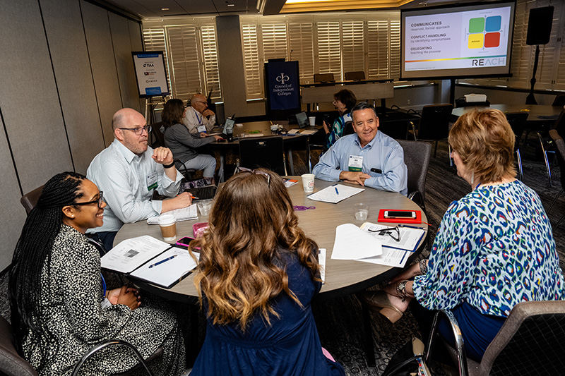 Participants discuss topics at roundtables