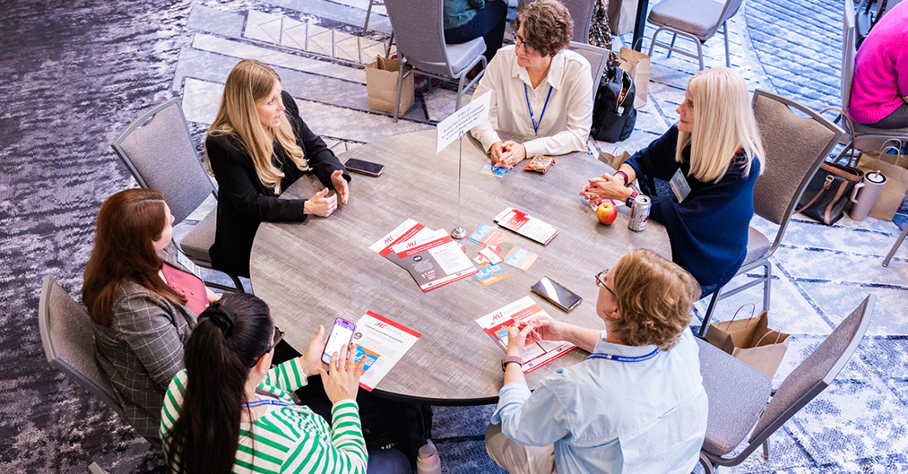 Six participants discuss a topic at a roundtable