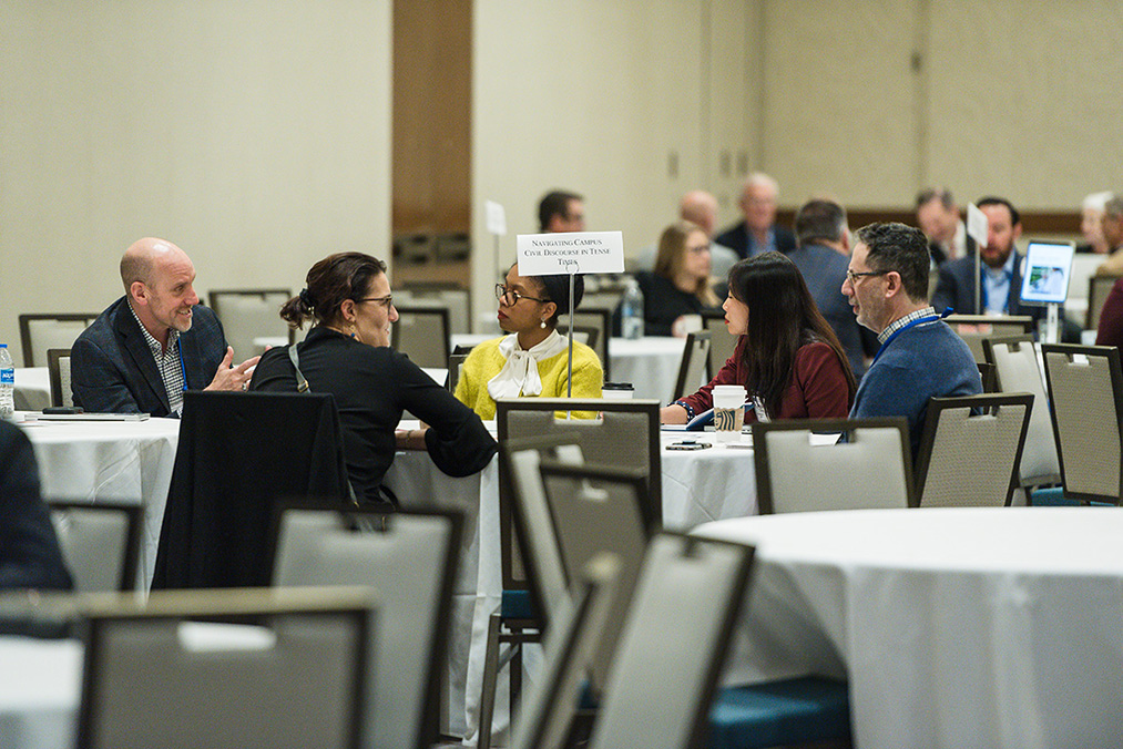 Participants seated at roundtable discussion session