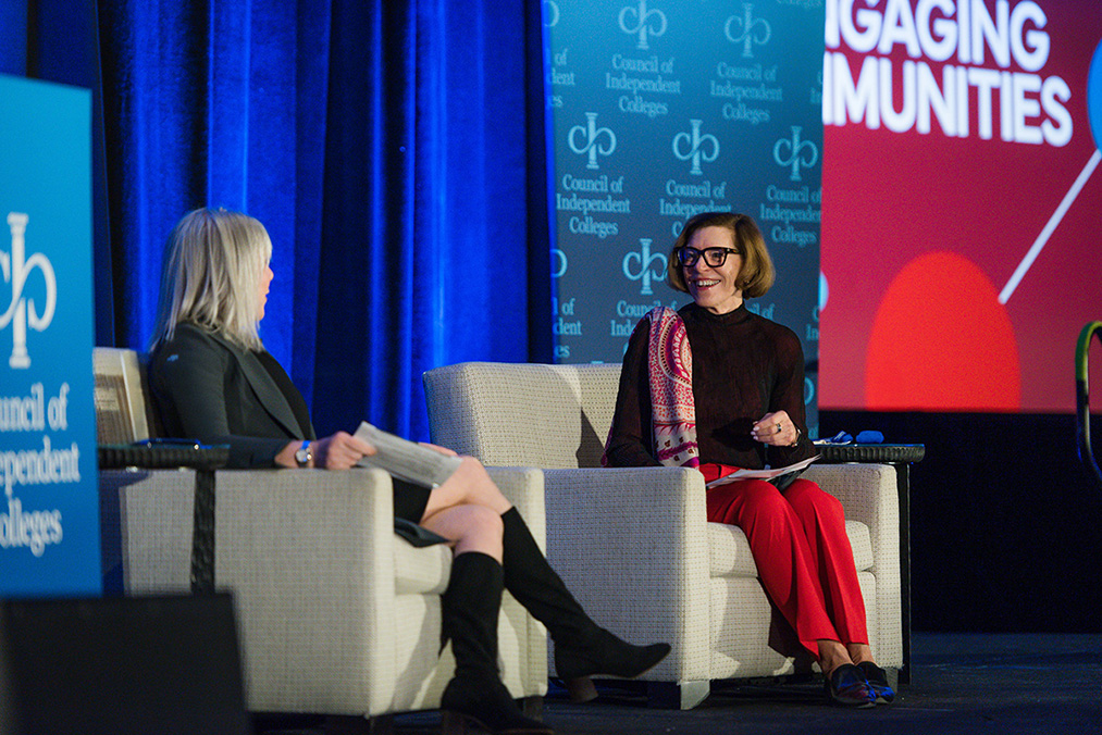 Marjorie Hass and Barbara Hetrick seated on stage during closing plenary session