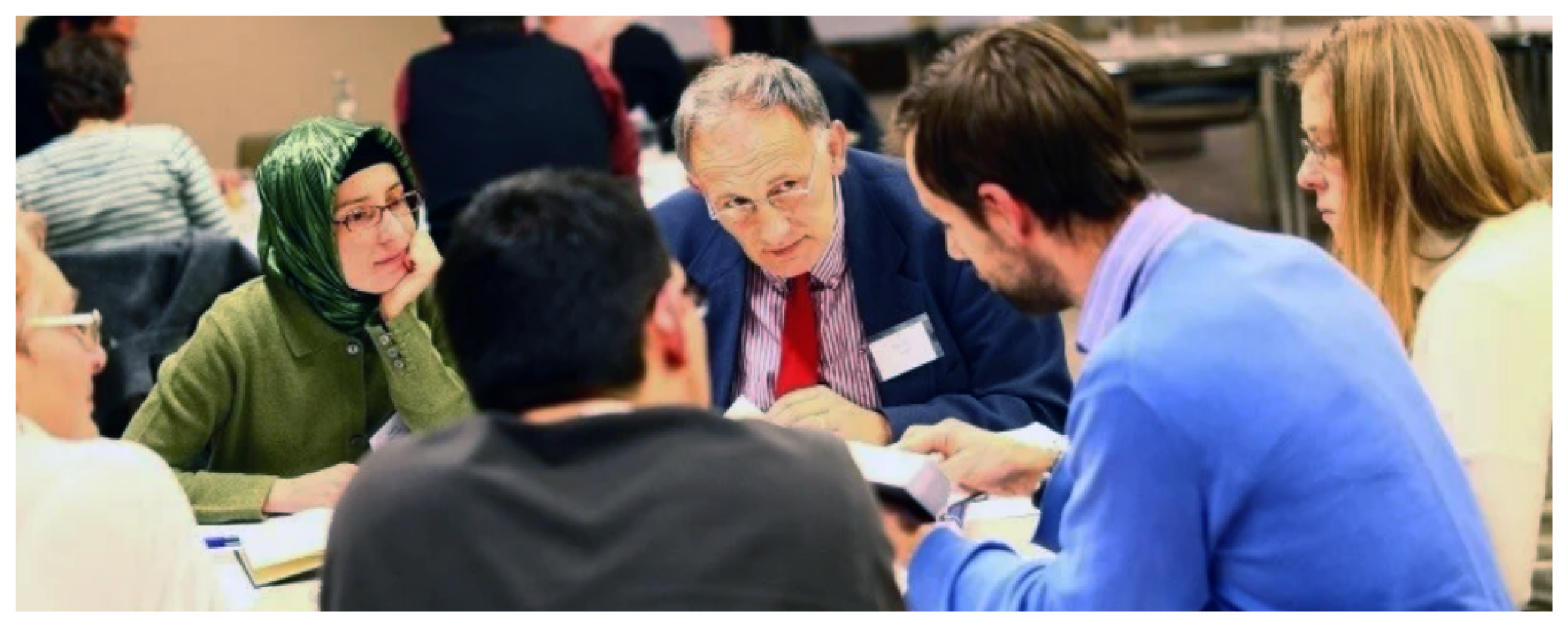 Individuals seated at a table in discussion